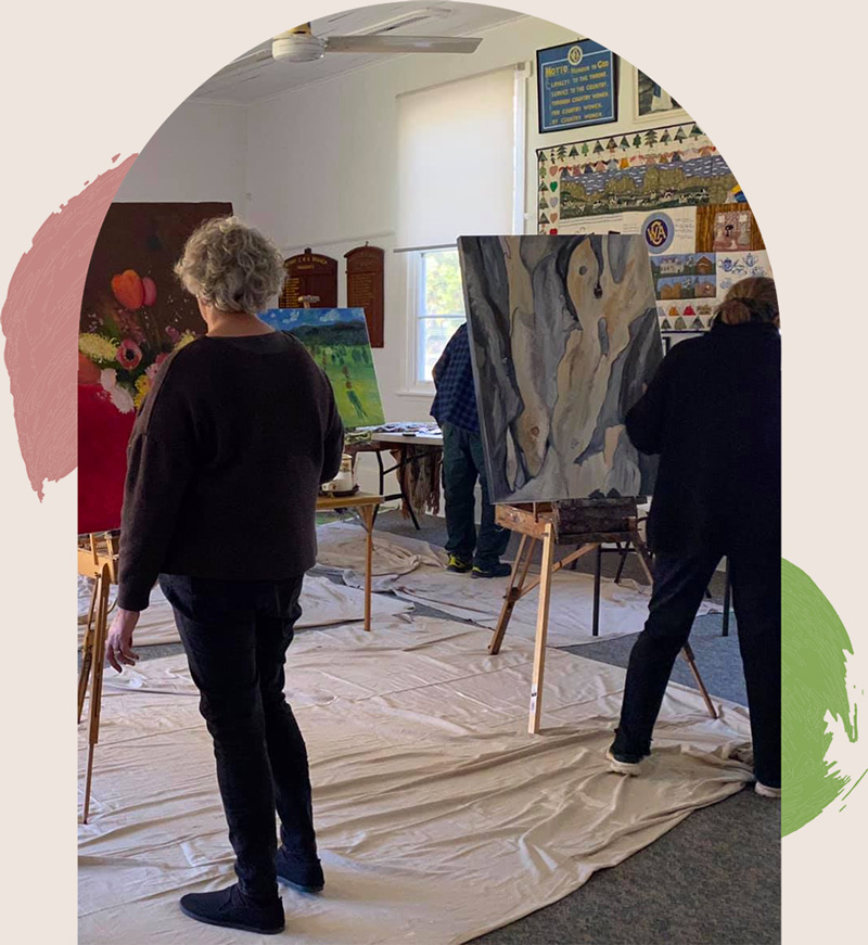 Two people painting in an art class in Todi